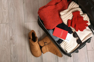 Open suitcase for a winter vacation