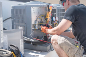 Air conditioner being repaired by an HVAC technician.