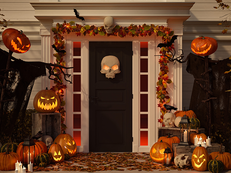 House with Jack-O-Lanterns and halloween decor on porch