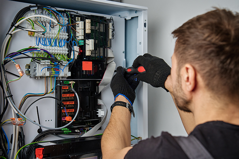 HVAC tech inspecting the inside of a unit.