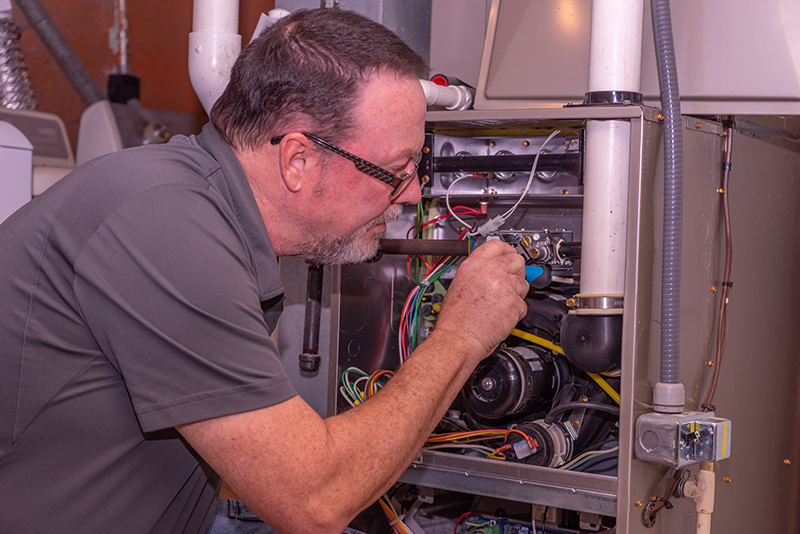 HVAC technician inspecting a system.