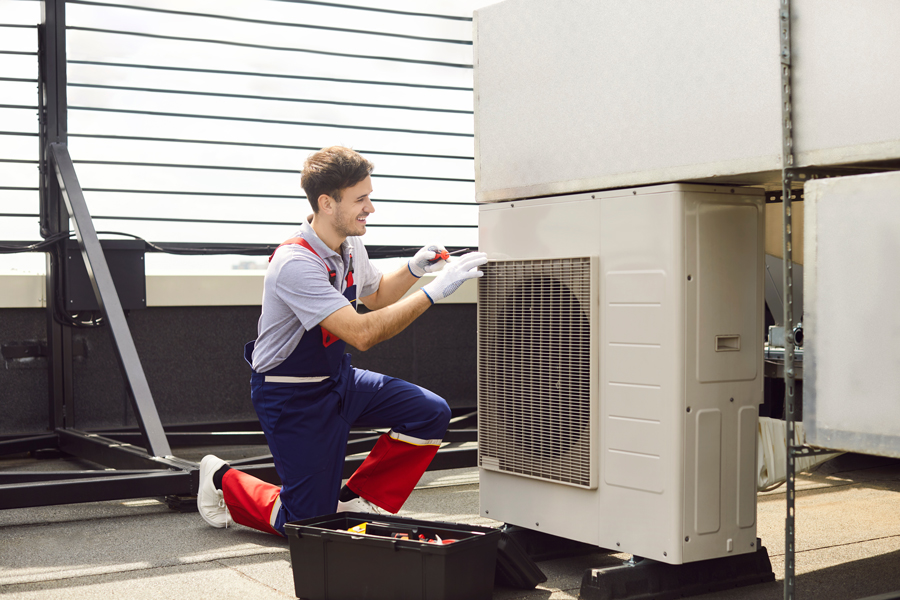 Technician repairing heating and cooling vent