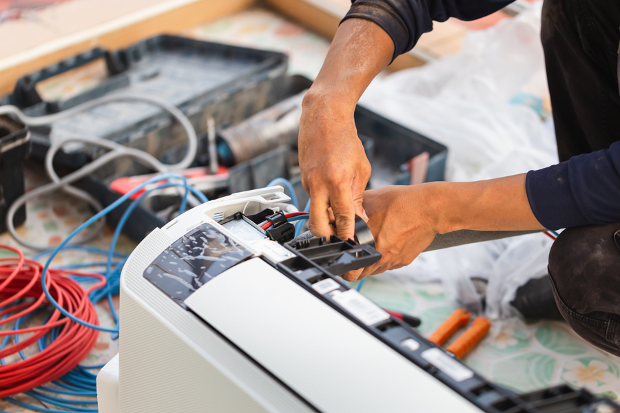 HVAC technician installing an AC unit