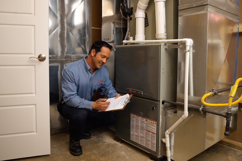 HVAC technician repairing a heating unit