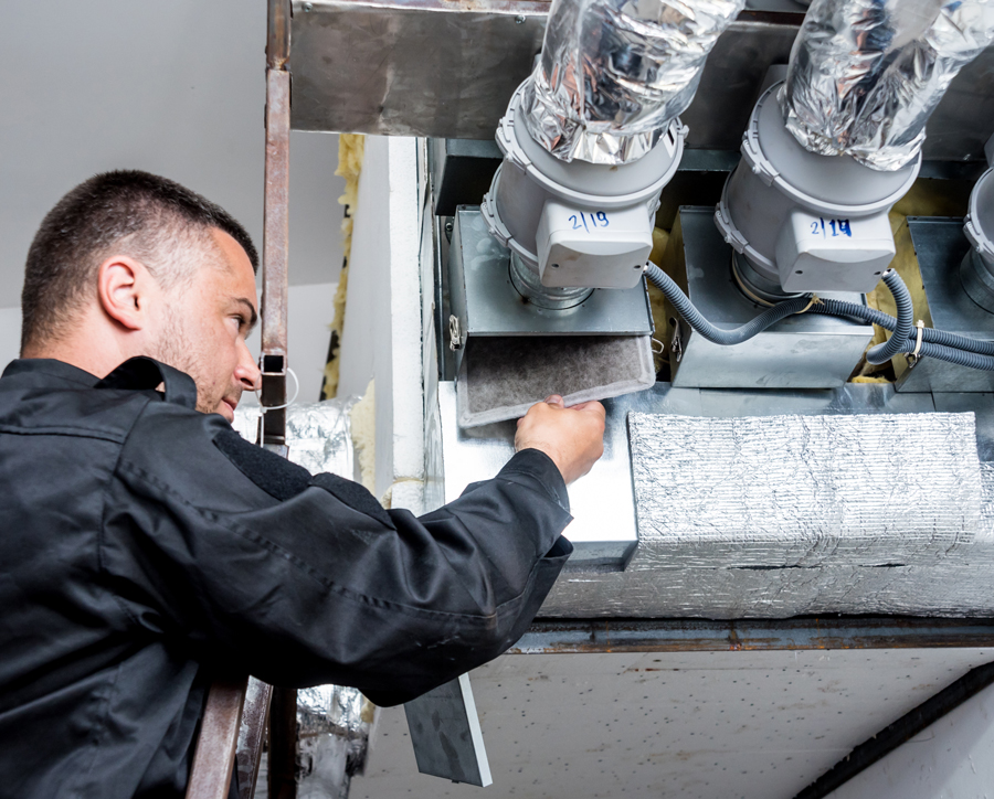 HVAC technician repairing ductwork
